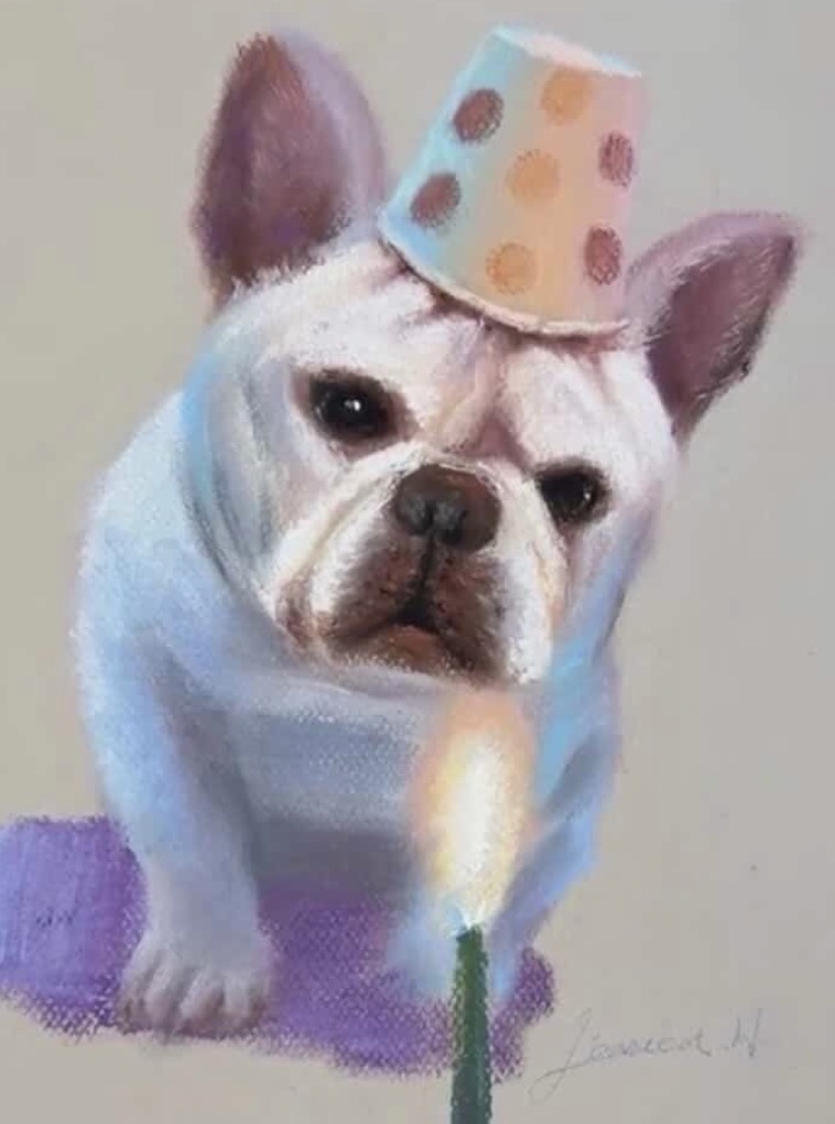 Soft pastel portrait of a small dog wearing a party hat beside a candle.
